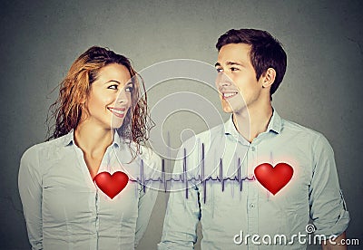 Man woman looking at each other with red hearts linked by cardiogram Stock Photo