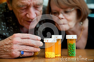 Man and woman looking at prescription medications Stock Photo