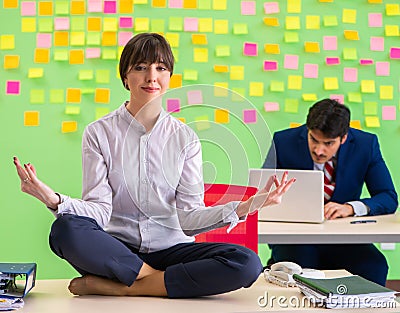 Man and woman in the office with many conflicting priorities in Stock Photo