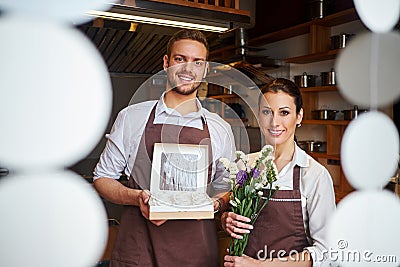 Man and woman in pastry shop or kitchen of bakery. Profession preparation confectionery products Stock Photo