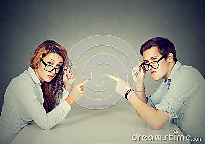 Man woman pointing fingers at each other blaming each other Stock Photo