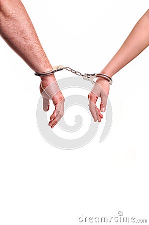 Man and woman's hands handcuffed together concept of love Stock Photo