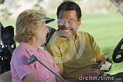 Man And Woman With Scorecard Stock Photo