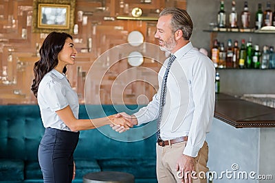 Man and woman shaking hands at meeting Stock Photo