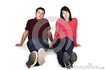 Man and woman sitting on floor, front view Stock Photo