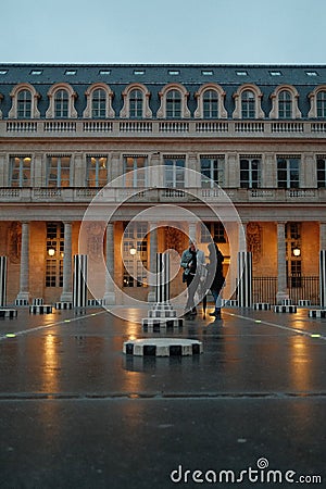 Man and woman standing in the courtyard of the Palais-Royal. Paris, France Editorial Stock Photo