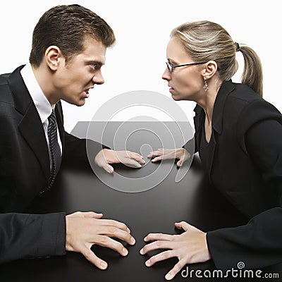 Man and woman staring at each other with hostile expressions. Stock Photo