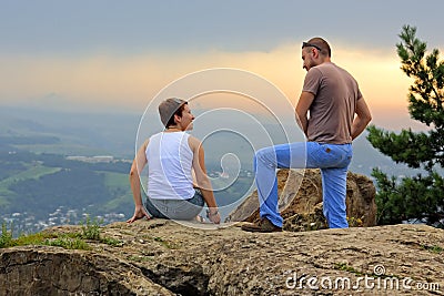 Man and woman on the top of the mountain at sunset Editorial Stock Photo