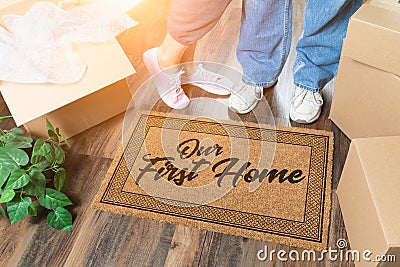 Man and Woman Unpacking Near Our First Home Welcome Mat, Moving Boxes and Plant Stock Photo