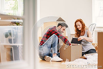 Man and woman unpacking stuff after relocation to new home Stock Photo