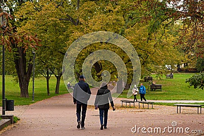 Man and woman are walking and talking on Letna Park in Autumn 2020 on Prague 6, during quarantine period due to outbreak of COVID- Editorial Stock Photo