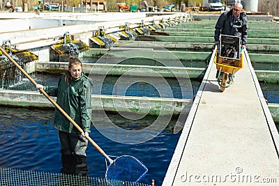 Man and woman working at fish farm Stock Photo