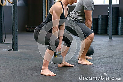 Man and woman working out with kettle weights Stock Photo