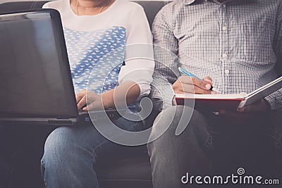 Man and woman workmate working on laptop and notepad in office Stock Photo