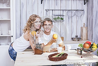 Man and woman young and beautiful couple in the kitchen home coo Stock Photo