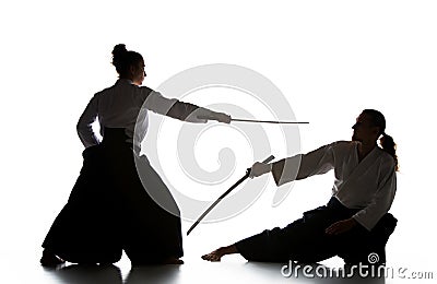 Man and woman fighting and training aikido on white studio background Stock Photo