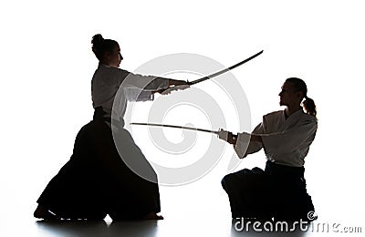 Man and woman fighting and training aikido on white studio background Stock Photo