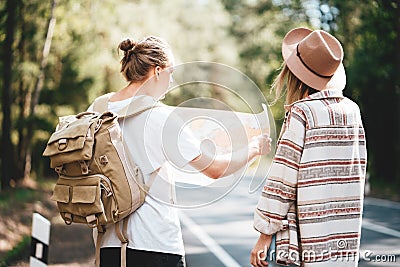 Ypung hipster couple hiking on forest road Stock Photo