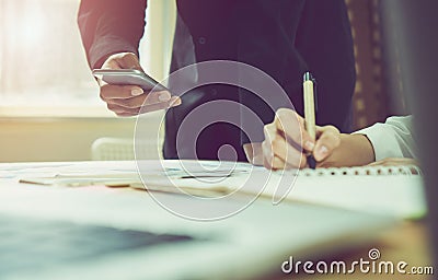 Man and women working on wooden desk in office in morning light. The concept of modern work with advanced technology. vintage effe Stock Photo