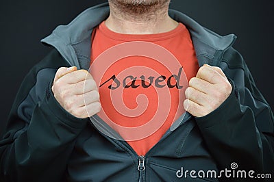 A man with the word saved on his t-shirt Stock Photo