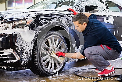 Man worker on a car wash Stock Photo