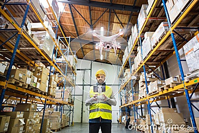 Man with drone in a warehouse. Stock Photo
