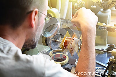 A man producing an electrical copper coil for high-voltage trans Editorial Stock Photo