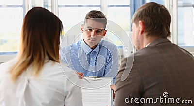 Man worker in suit give contract paper to clients, agreement terms, put signature Stock Photo