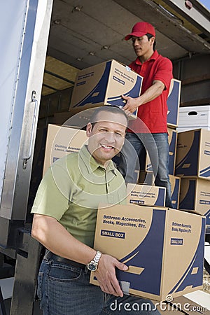 Man With Worker Unloading Truck Of Cardboard Boxes Stock Photo