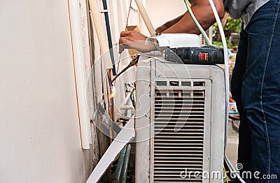 man worker working use electric machine for Air pipe welding. technician male install air condition tube on wall. professional Stock Photo