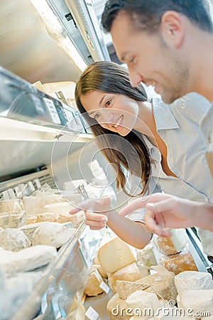man working with display cheese Stock Photo