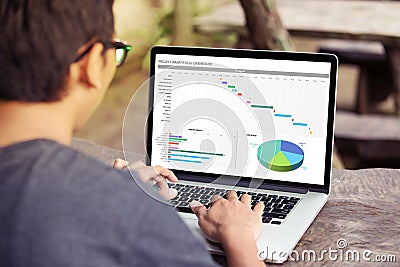Man working with excel project dashboard on laptop / computer Stock Photo