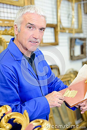 Man working with gold leaf Stock Photo