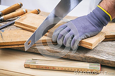 Man working with a hand saw Stock Photo