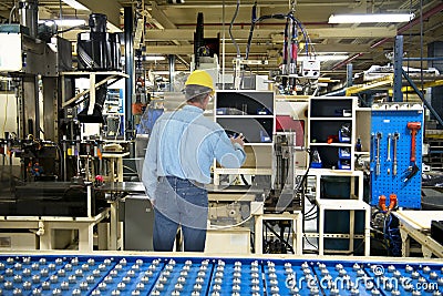 Man Working in Industrial Manufacturing Factory Stock Photo