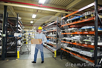 Man Working in Industrial Manufacturing Warehouse Stock Photo