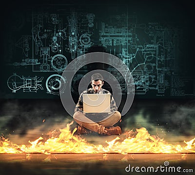Firewall protection. Man working on laptop in front of a firewall. Stock Photo