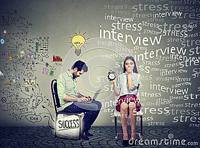 Man working on laptop generating ideas next to a stressed anxious woman Stock Photo