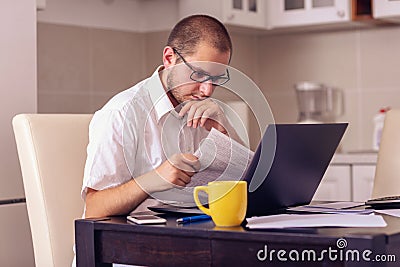 Man working on laptop at home office Stock Photo