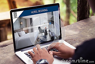 Man working on laptop, searching for lodging using on-line web service, booking a hotel on website Stock Photo