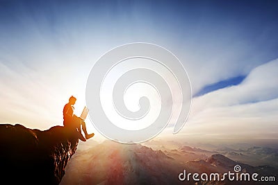 Man working on notebook on top of the mountains. Internet freedom Stock Photo