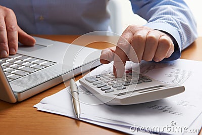 Man Working Out Household Finances Stock Photo