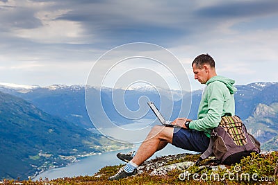 Man working outdoors with laptop Stock Photo