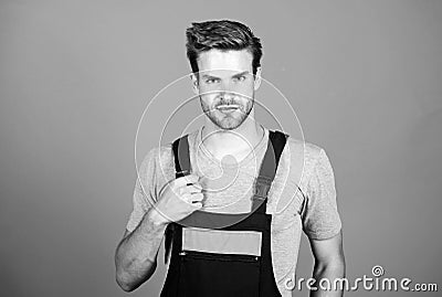 Man working in repair shop. man builder in work clothes. man build house. skilled architect repair. worker purple Stock Photo