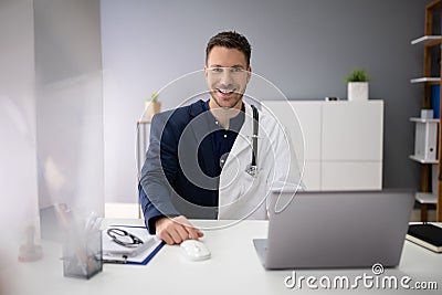 Man Working Two Jobs In Office Stock Photo