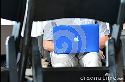 Man works on Apple laptop Editorial Stock Photo