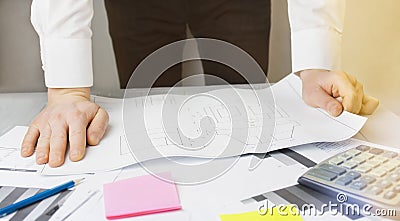 A man works with blueprints. Close-up of the hands of a working man. Businessman works with papers. Brainstorm. Business goals Stock Photo