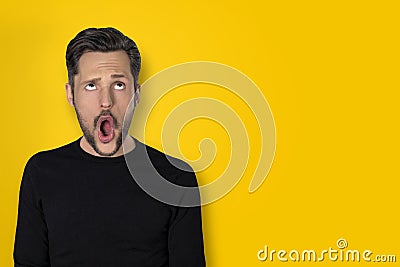 Man with a wow expression on a yellow background Stock Photo