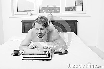 Man writer lay bed bedclothes working book. Writer romantic author used old fashioned typewriter. Author having Stock Photo