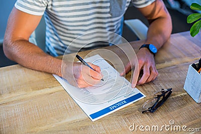 Man writing curriculum vitae Stock Photo